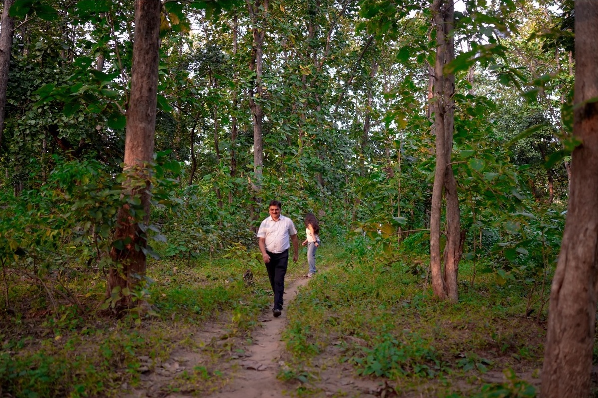 Rosewood Villas Pench second forest trail walk with thick greenery and rustic path.