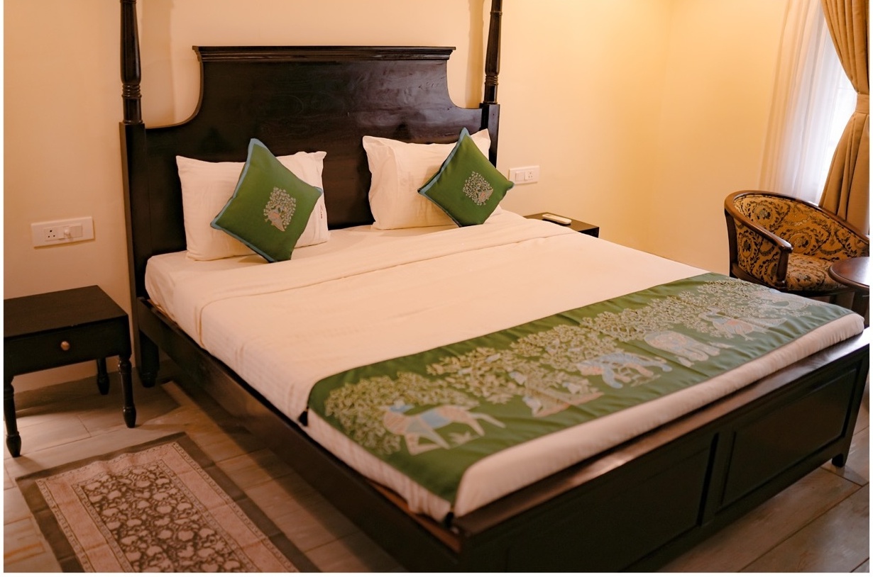 Rosewood Villas Pench luxury bedroom interior with king-size bed and warm lighting.