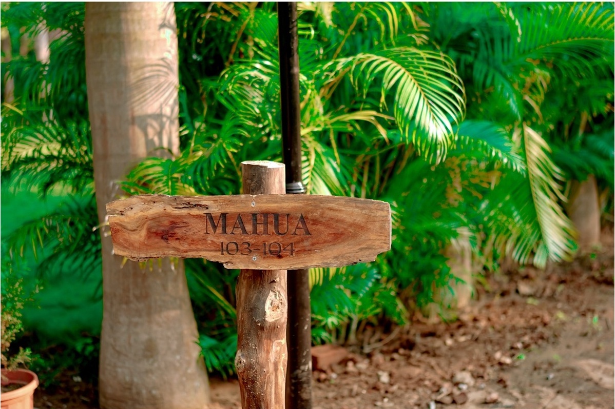 Wooden signboard for Mahua villa, echoing local craftsmanship near Pench villages.